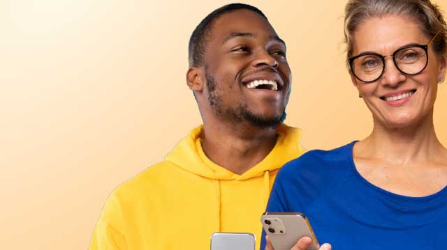 Smiling man and woman holding cell phones